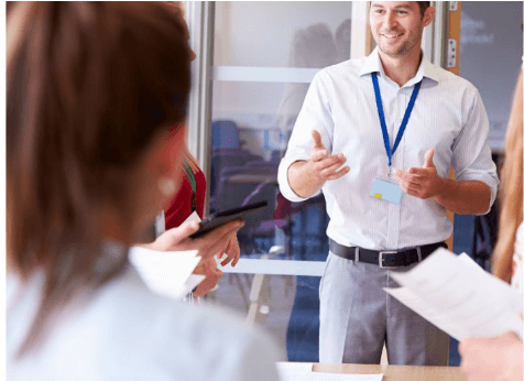 Professional assessor and trainer with lanyard badge conducting Recognition of Prior Learning evaluation workshop
